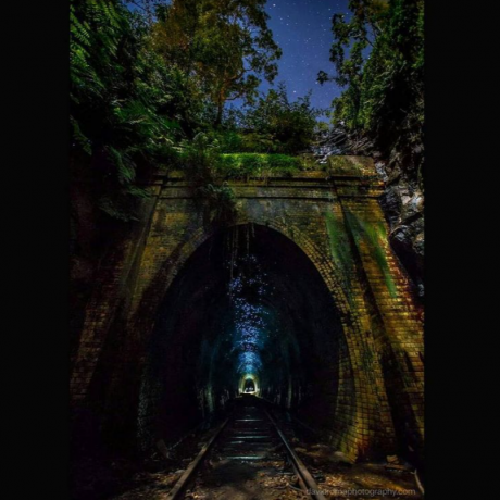 An Australian tunnel emits a bluish glow in the dark.