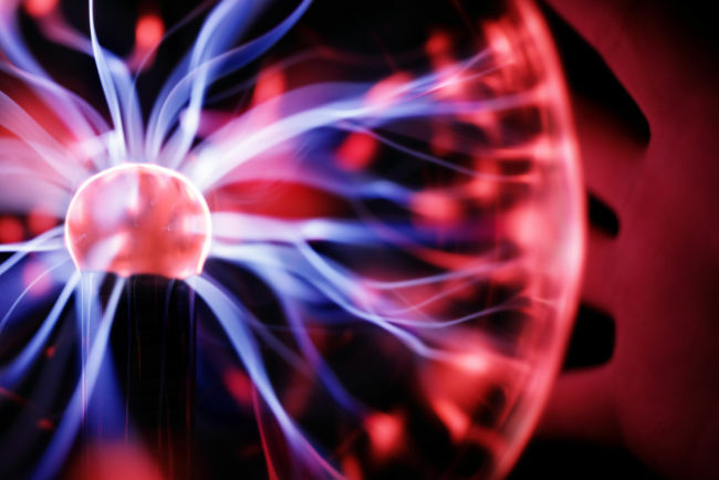 Moving charges in a specific gas brings out the color pattern of the plasma globe.