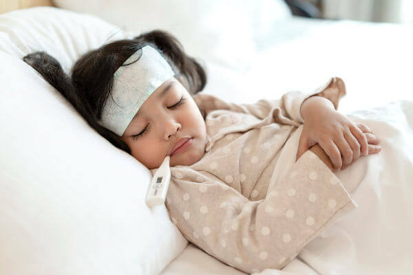 A child with a fever needs rest and should not go to school.