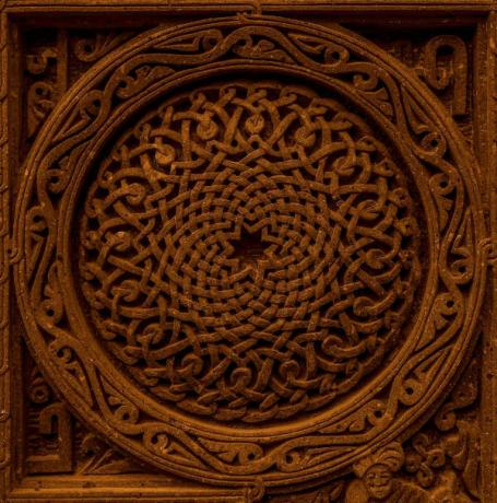 Rosette, with a representation of a mandala, on the wall of a Catholic church.
