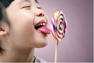 The sugar in the lollipop breaks down faster in the presence of the body's enzymes