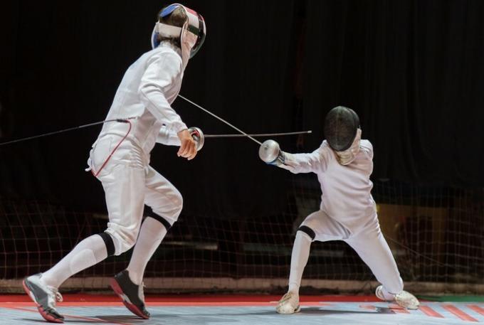 Two athletes in a fencing match